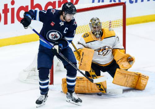 John Woods / THE CANADIAN PRESS files
                                Winnipeg Jets captain Adam Lowry distracts Nashville Predators goaltender Juuse Saros.
