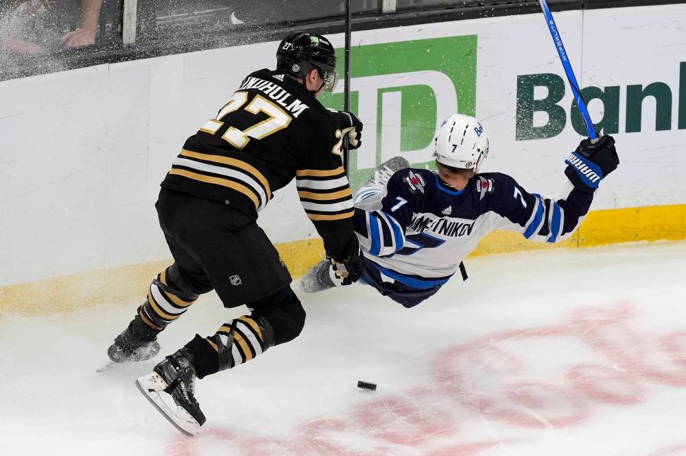(AP Photo/Michael Dwyer)
Boston Bruins’ Hampus Lindholm and Winnipeg Jets’ Vladislav Namestnikov go hard into the corner during the first period.