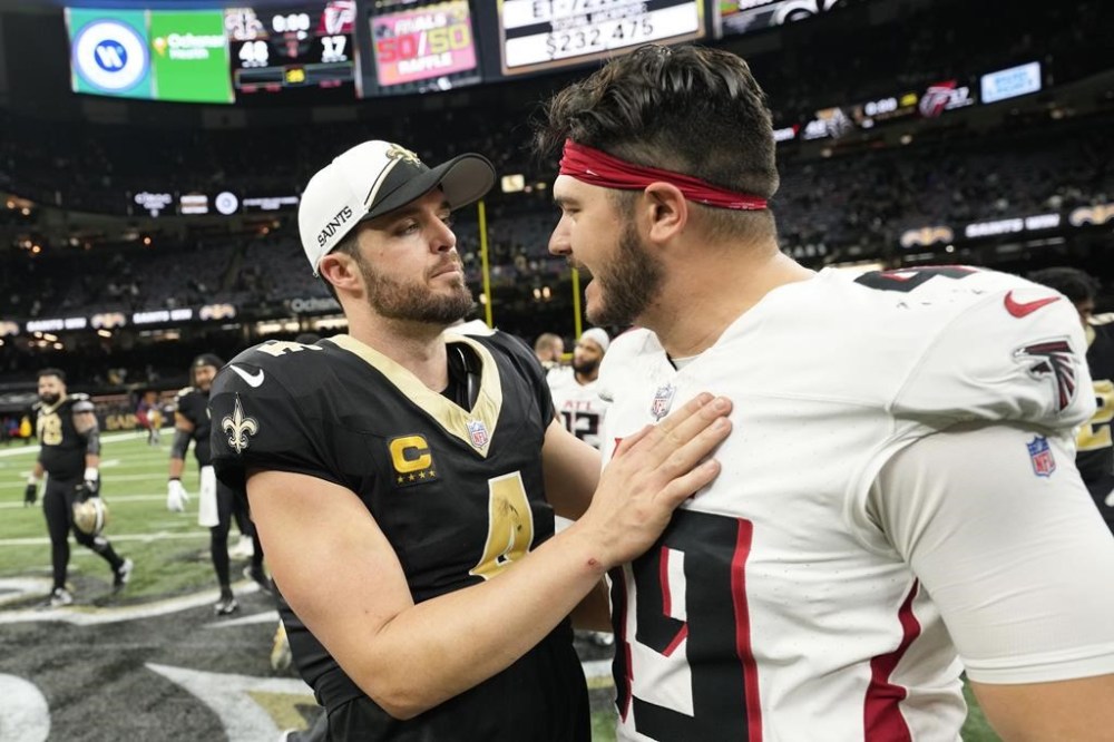New Orleans Saints quarterback Derek Carr (4) greets Atlanta Falcons long snapper Liam McCullough (49) after an NFL football game in New Orleans, Sunday, Jan. 7, 2024. (AP Photo/Gerald Herbert)