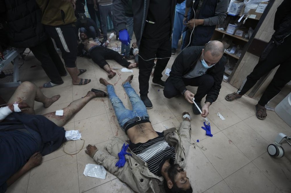 Palestinians wounded in the Israeli bombardment of the Gaza Strip are brought to Al Aqsa hospital in Deir al Balah, Gaza Strip, Sunday, Jan. 7, 2024. (AP Photo/Adel Hana)