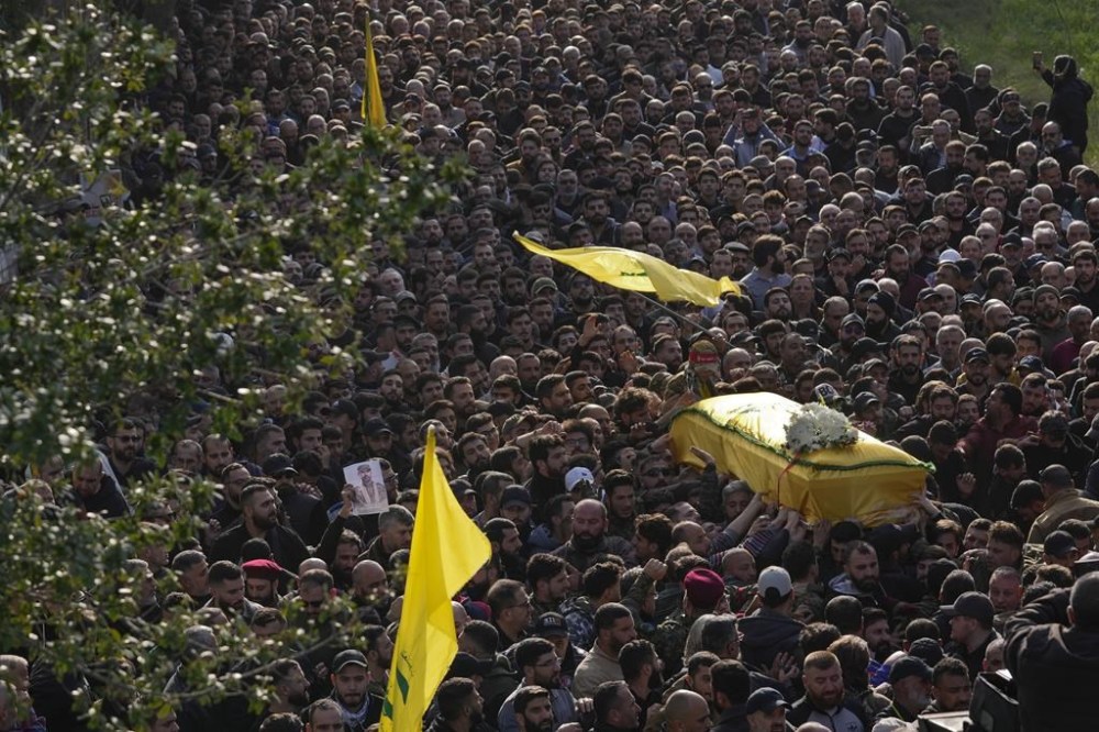 Mourners carry the coffin of senior Hezbollah commander Wissam Tawil, during his funeral procession in the village of Khirbet Selm, south Lebanon, Tuesday, Jan. 9, 2024. The elite Hezbollah commander who was killed in an Israeli airstrike Monday in southern Lebanon fought for the group for decades and took part in some of its biggest battles. (AP Photo/Hussein Malla)