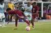 Honduras' Deybi Flores, middle is tripped between Qatar's Yusuf Abdurisag, left, and Tameem Alabdulla, right, during the first half of a CONCACAF Gold Cup soccer match Thursday, June 29, 2023, in Glendale, Ariz. Toronto FC has signed Honduran international midfielder Flores to a two-year contract, the club announced Tuesday. THE CANADIAN PRESS/AP/Darryl Webb