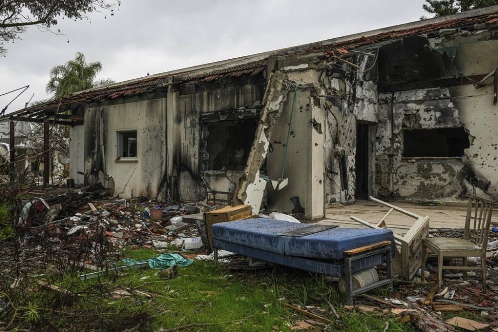 A battle-scarred home in Kibbutz Be'eri, an Israeli communal farm on the Gaza border, is seen Thursday, Jan. 11, 2024. Hamas held more than a dozen hostages in the home when it overran southern Israel on Oct. 7. At the end of an hours-long battle between the militants and Israeli forces, only two hostages survived, and relatives of the slain hostages now demand to know if their loved ones were killed by friendly fire from an Israeli tank. (AP Photo/Tsafrir Abayov)