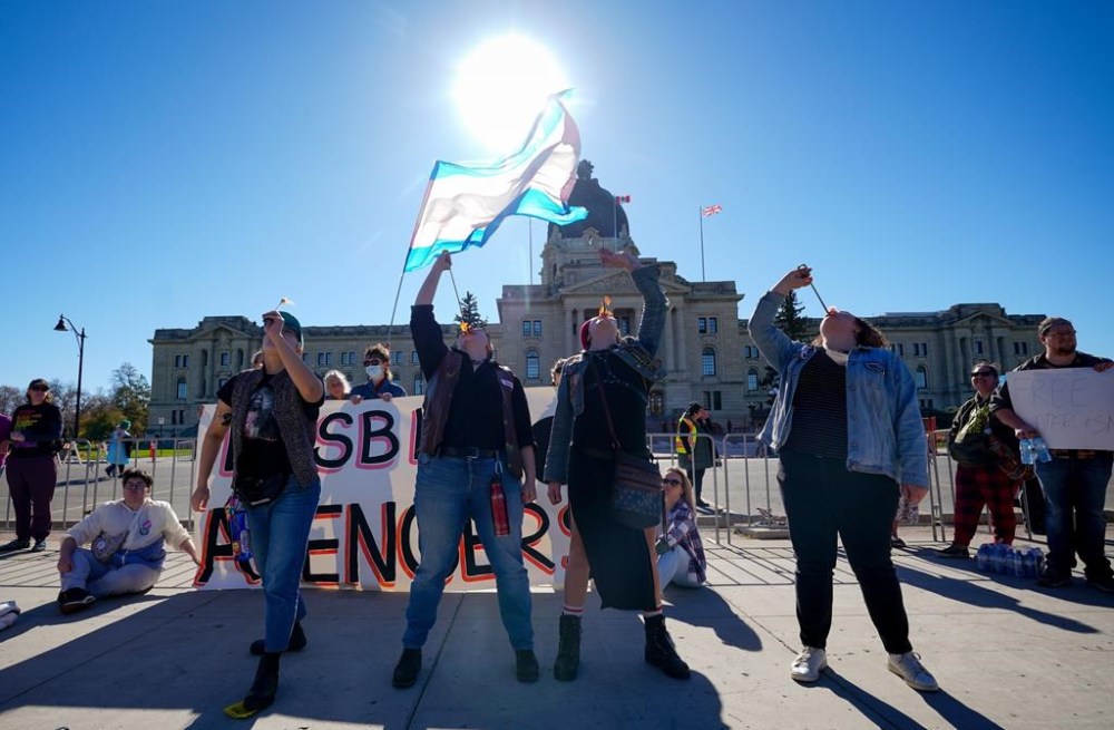 People attend a rally opposing the Saskatchewan government's proposed legislation on its pronoun policy in front of the Saskatchewan Legislative Building in Regina, Tuesday, Oct. 10, 2023. THE CANADIAN PRESS/Heywood Yu