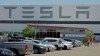 FILE - A man walks in the Tesla plant parking lot, May 11, 2020, in Fremont, Calif. Factory workers at Tesla have been told to expect pay raises in 2024, a move that comes as the United Auto Workers union tries to organize the electric vehicle maker's U.S. plants. The UAW said Thursday, Jan. 11, 2024, that Tesla workers have told the union about company statements on the raises, which did not give details about the size of the increases. (AP Photo/Ben Margot, File)