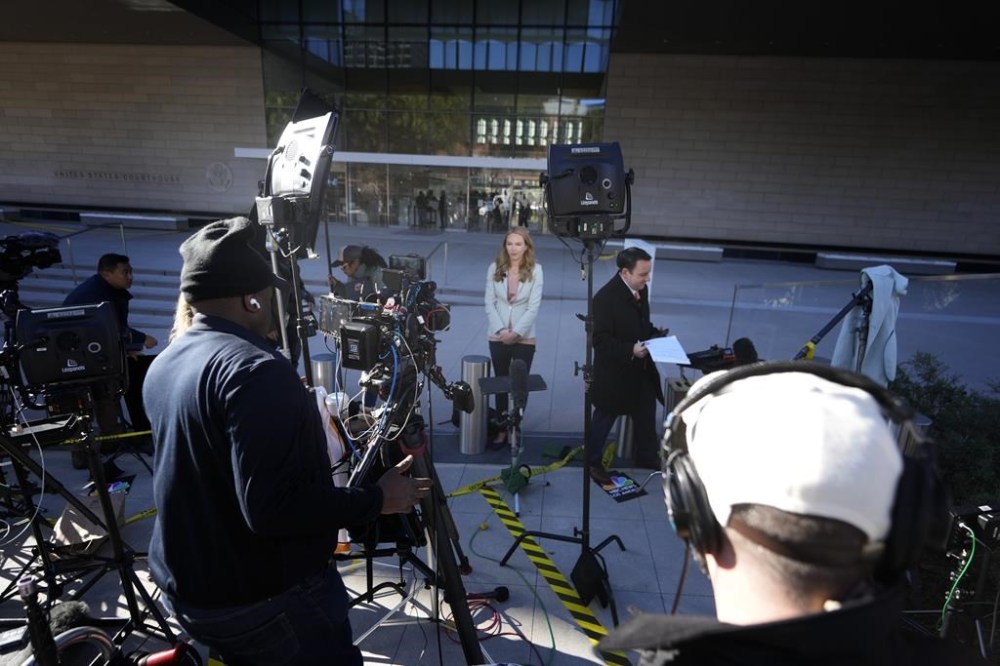 News crews wait in front of a federal courthouse Thursday, Jan. 11, 2024, in Los Angeles. Hunter Biden, President Joe Biden's son, will head back to court on Thursday for arraignment in Los Angeles on federal tax charges filed after the collapse of a plea deal that could have spared him the spectacle of a criminal trial during the 2024 campaign. (AP Photo/Damian Dovarganes)