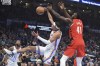 Oklahoma City Thunder forward Ousmane Dieng, center, tries to get to a rebound before Portland Trail Blazers center Ibou Badji, right, can during the first half of an NBA basketball game Thursday, Jan. 11, 2024, in Oklahoma City. (AP Photo/Kyle Phillips)