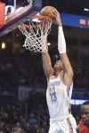 Oklahoma City Thunder forward Ousmane Dieng dunks against the Portland Trail Blazers during the second half of an NBA basketball game Thursday, Jan. 11, 2024, in Oklahoma City. (AP Photo/Kyle Phillips)