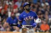 FILE - Texas Rangers' Adolis Garcia hits a home run during the third inning of Game 7 of the baseball AL Championship Series against the Houston Astros, Oct. 23, 2023, in Houston. All-Star catcher Jonah Heim and six other players have agreed to one-year contracts with the Rangers, but the World Series champions didn’t reach a deal with García. (AP Photo/David J. Phillip, File)