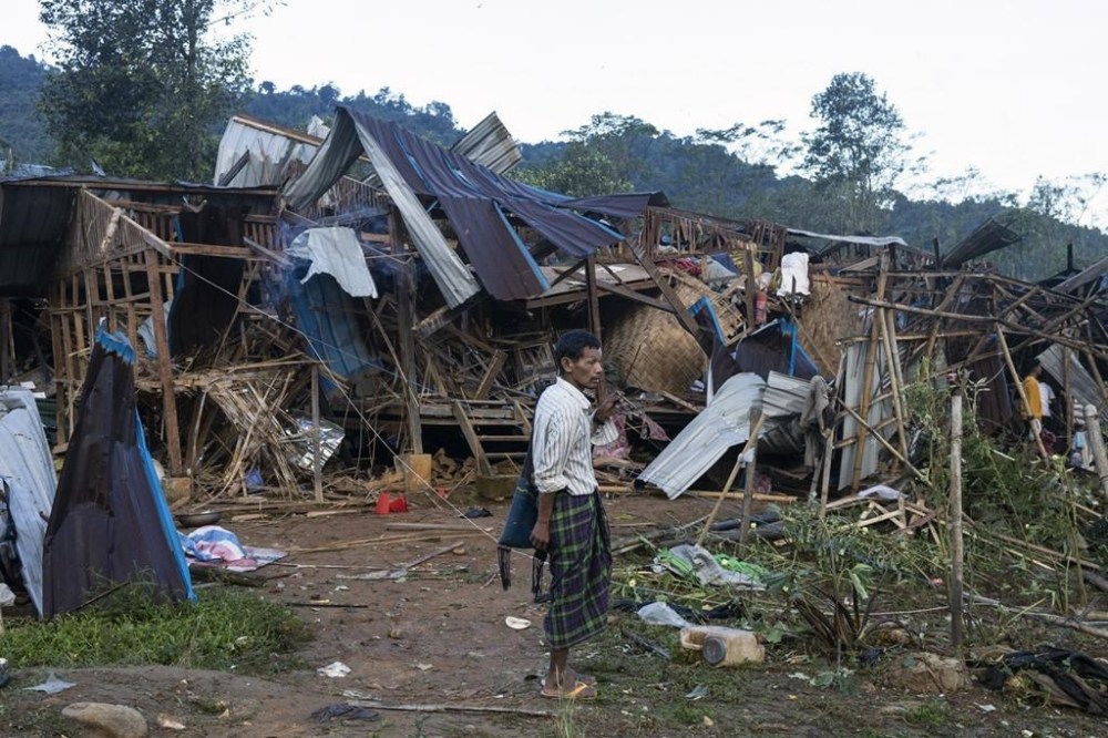 FILE - A man looks on at homes destroyed after air and artillery strikes in Mung Lai Hkyet displacement camp, in Laiza, Myanmar, Tuesday Oct. 10, 2023. China says on Friday, Jan. 12, 2024, that Myanmar’s military has reached a cease-fire agreement with an alliance of three ethnic minority guerrilla groups that it has been battling in the north. (AP Photo, File)