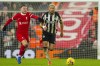 Liverpool's Alexis Mac Allister, left, duels for the ball with Newcastle's Joelinton during the English Premier League soccer match between Liverpool and Newcastle, at Anfield stadium in Liverpool, England, Monday, Jan. 1, 2024. (AP Photo/Jon Super)
