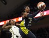 FILE - Dallas Wings guard Arike Ogunbowale (24) shoots next to Minnesota Lynx guard Diamond Miller, left, during the first half of a WNBA basketball game Aug. 24, 2023, in Arlington, Texas. The WNBA is using some fresh faces in its Player Marketing Agreement cohort this season. The league's past two Rookie of the Year winners Aliyah Boston, of Indiana, and Rhyne Howard, of Atlanta, are two of the six players chosen this offseason to take part in the program. They are joined by Washington's Shakira Austin, Connecticut's Brionna Jones, Seattle's Jewell Loyd and Ogunbowale. (AP Photo/Tony Gutierrez, File)