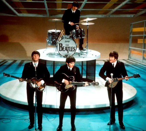 FILE -The Beatles, foreground from left, Paul McCartney, George Harrison, John Lennon and Ringo Starr on drums perform on the CBS 