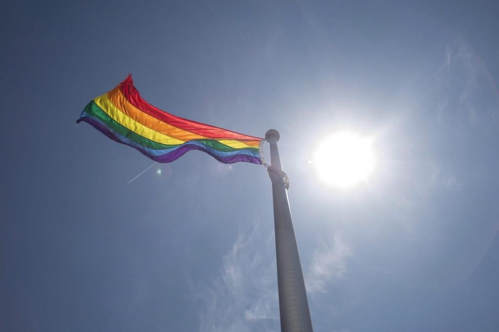 A gay employee of Global Affairs Canada posted abroad has won a tribunal ruling that Ottawa must compensate travelling expenses for any diplomat in a same-sex couple attending a surrogacy birth. A rainbow flag is seen at Toronto City Hall in Toronto on Tuesday, May 31, 2016.THE CANADIAN PRESS/Eduardo Lima