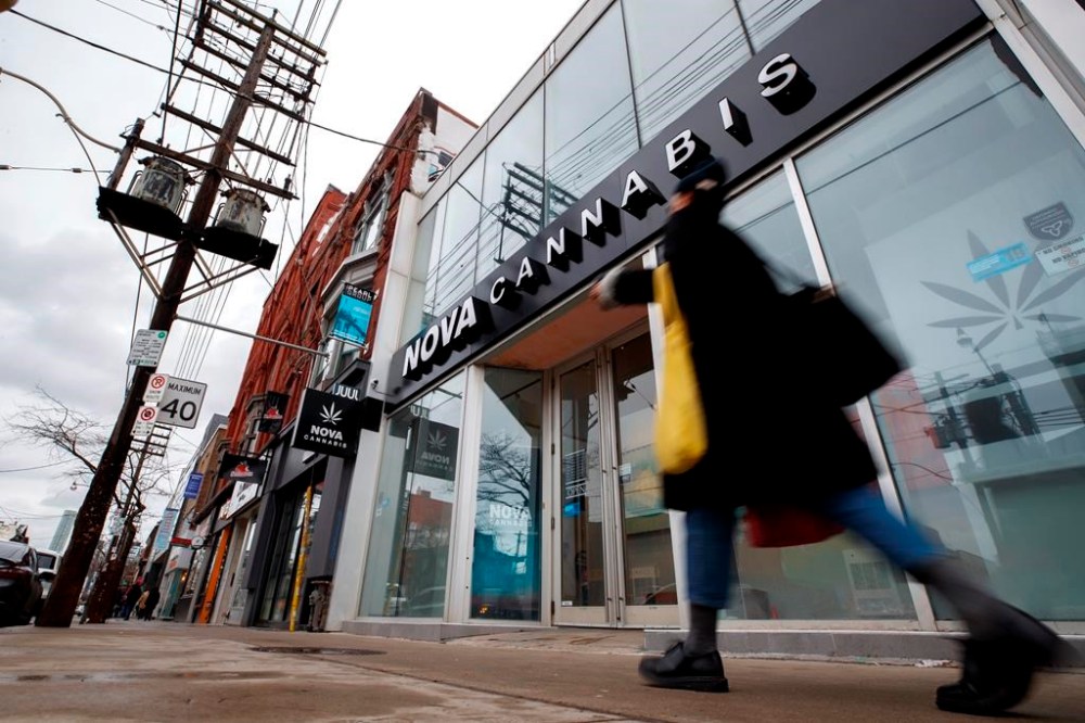 An annual survey from Health Canada shows 73 per cent of respondents are buying their cannabis from legal sources. A person walks by a Cannabis dispensary on Queen St. in Toronto, Monday, Jan. 6, 2020. THE CANADIAN PRESS/Cole Burston