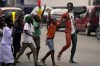 Ivorians sing and dance on the street ahead of the African Cup of Nations Group A soccer match between Ivory Coast and Guinea-Bissau in Abidjan, Ivory Coast, Saturday, Jan. 13, 2024. (AP Photo/Themba Hadebe)