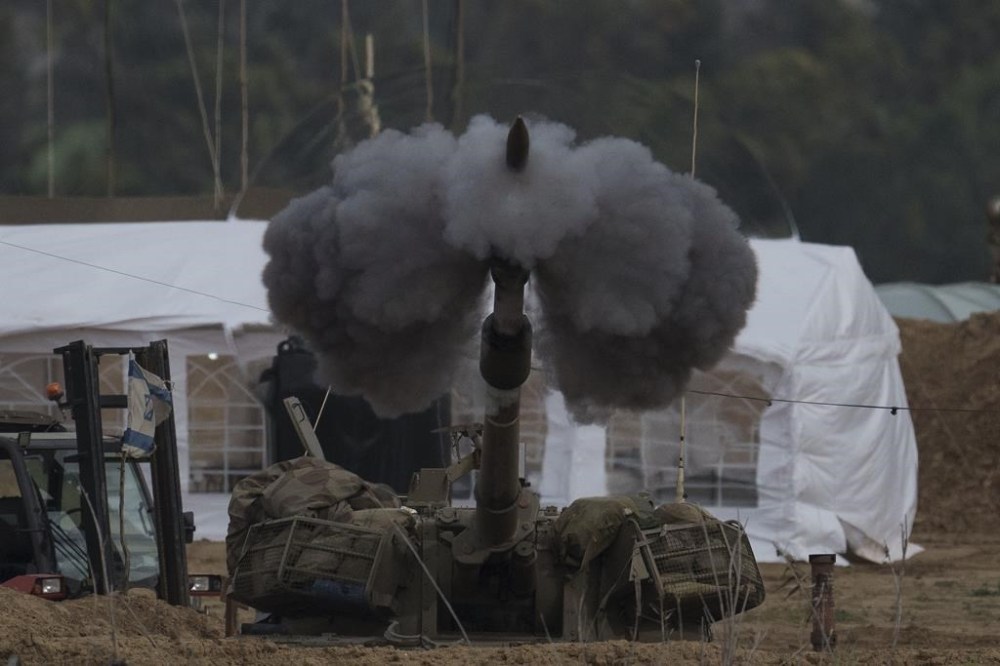 An Israeli mobile artillery unit fires a shell from southern Israel towards the Gaza Strip, in a position near the Israel-Gaza border , Sunday, Jan. 14, 2024. Sunday marks 100 days of war between Israel and Hamas, after Hamas attacked Israel on Oct. 7th, killing some 1,200 people, mostly civilians, and taking 250 others hostage. In the Gaza Strip, health authorities say the death toll already has eclipsed 23,000 people. (AP Photo/Leo Correa)