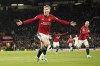 Manchester United's Rasmus Hojlund celebrates with teammates after scoring his side's opening goal during the English Premier League soccer match between Manchester United and Tottenham Hotspur at the Old Trafford stadium in Manchester, England, Sunday, Jan.14, 2024. (AP Photo/Dave Thompson)
