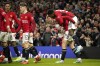 Manchester United's Rasmus Hojlund, second right, celebrates with teammates after scoring his side's opening goal during the English Premier League soccer match between Manchester United and Tottenham Hotspur at the Old Trafford stadium in Manchester, England, Sunday, Jan.14, 2024. (AP Photo/Dave Thompson)