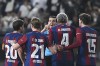 Referee Juan Martinez Munuera, center, speaks to Barcelona players, including Barcelona's Ronald Araujo, during the Spanish Super Cup final soccer match between Real Madrid and Barcelona at Al-Awwal Park Stadium in Riyadh, Saudi Arabia, Sunday, Jan. 14, 2024. (AP Photo)