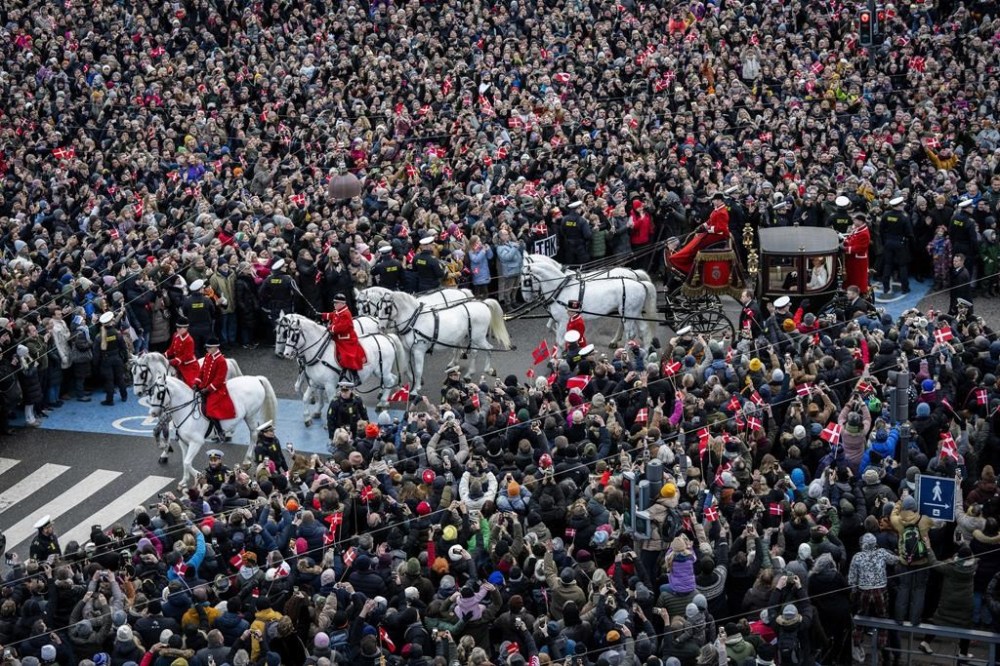 Denmark's King Frederik X and his wife Queen Mary ride in a coach back to Amalienborg Palace in Copenhagen, Denmark, Sunday, Jan. 14, 2024. Queen Margrethe II has become Denmark's first monarch to abdicate in nearly 900 years when she handed over the throne to her son, who has become King Frederik X. (Ida Marie Odgaard/Ritzau Scanpix via AP)