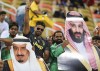 FILE - Saudi fans holds pictures of Saudi Arabia's King Salman, left, and Saudi Crown Prince Mohammed bin Salman ahead of the Italian Super Cup final soccer match between AC Milan and Juventus at King Abdullah stadium in Jiddah, Saudi Arabia, on Jan. 16, 2019. Saudi Arabia revealed designs Monday Jan. 15, 2024 for a high-tech stadium atop a 200-meter high cliff near Riyadh where the kingdom plans to stage games at the 2034 World Cup. It will be named Prince Mohammed bin Salman Stadium for the crown prince of the oil-rich kingdom that wants to become the major player in world sports over the next decade. (AP Photo, File)