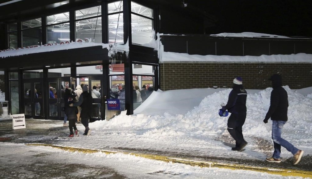 Scott County caucusgoers head into North Scott High School, Monday, Jan. 15, 2024, during the 2024 Iowa Republican caucuses in Eldridge, Iowa. (Roy Dabner/Quad City Times via AP)