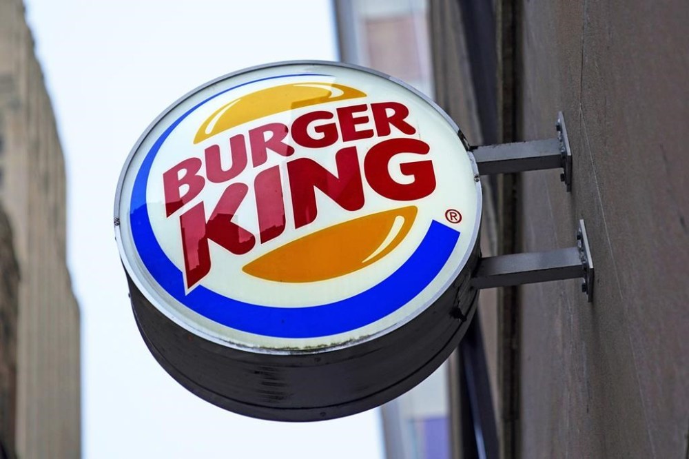The Burger King logo is displayed on a sign outside a restaurant in downtown Pittsburgh on Wednesday, Jan. 12, 2022. Restaurant Brands International Inc. says it has signed a deal to buy Carrols Restaurant Group, the largest Burger King franchisee in the United States, in a deal worth US$1 billion.THE CANADIAN PRESS/AP/Gene J. Puskar