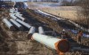 Alberta oil production hit an all-time record in November, as oilsands companies ramped up output to prepare for the imminent completion of the Trans Mountain pipeline expansion. Workers survey around pipe to start of right-of-way construction for the Trans Mountain Expansion Project, in Acheson, Alta., Tuesday, Dec. 3, 2019. THE CANADIAN PRESS/Jason Franson