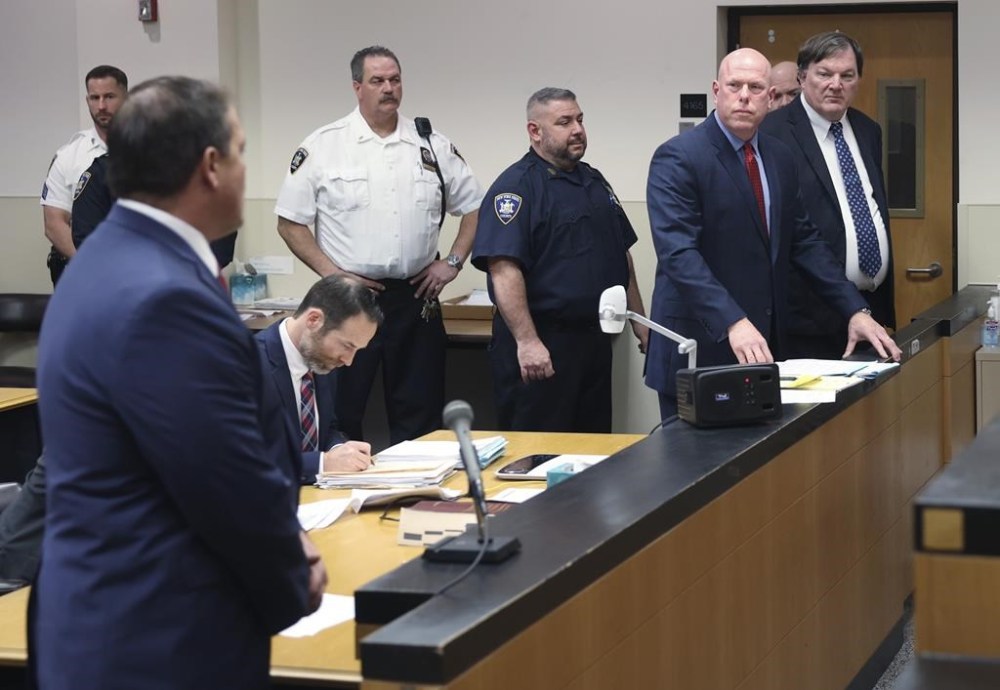 Suffolk County district attorney Ray Tierney, left, inside Judge Timothy P. Mazzei's courtroom at Suffolk County Court in Riverhead, N.Y. on Tuesday, Jan. 16, 2024, where alleged Gilgo Killer Rex Heurmann, right, was indicted in the death of Maureen Brainard-Barnes. (James Carbone/Newsday via AP)