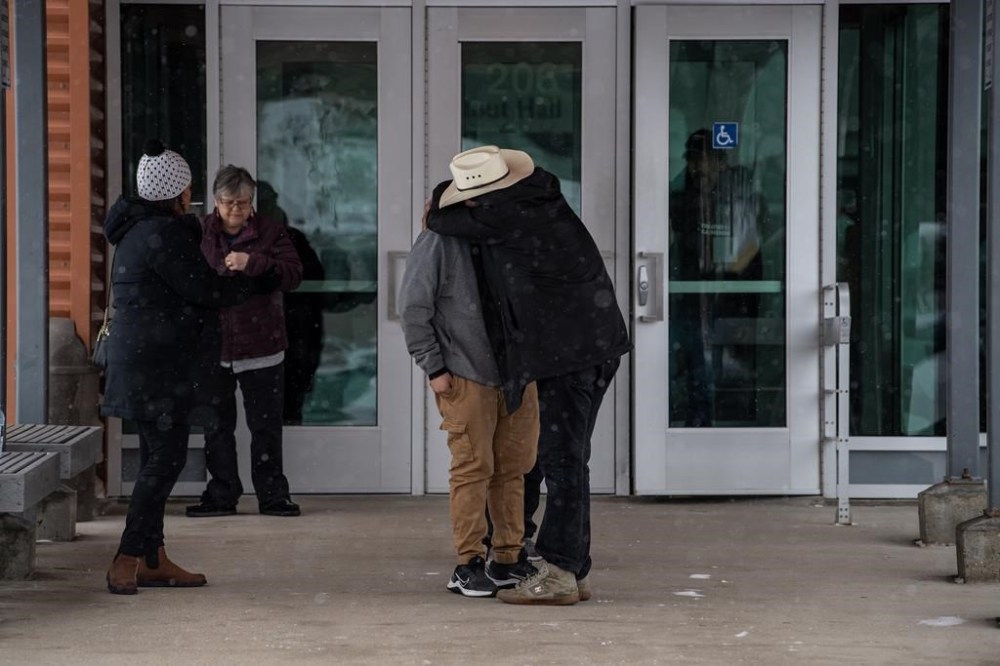 People comfort each other during a lunch break at the public coroner's inquest into the mass stabbings that happened on James Smith Cree Nation in 2022 in Melfort, Sask., Tuesday, Jan. 16, 2024. THE CANADIAN PRESS/Liam Richards