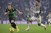 Sassuol's Ryan Flamingot, left, and Juventus Turin's Filip Kostic, right, challenge for the ball during the Serie A soccer match between Juventus Turin and Sassuolo Calcio in Turin, Italy, Tuesday, Jan. 16, 2024. (Marco Alpozzi/LaPresse via AP)