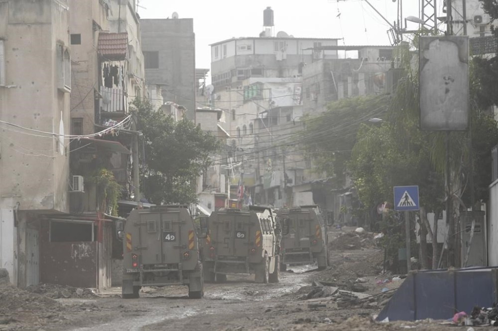 Israeli security forces are seen during a raid in the Tulkarem refugee camp, West Bank, Wednesday, Jan.17, 2024. An Israeli airstrike killed four Palestinians during a raid in the West Bank. The military says it targeted a group of militants who had opened fire and were throwing explosives at Israeli soldiers in the Tulkarem refugee camp. The Palestinian Health Ministry says four people were killed. (AP Photo/Nasser Nasser)