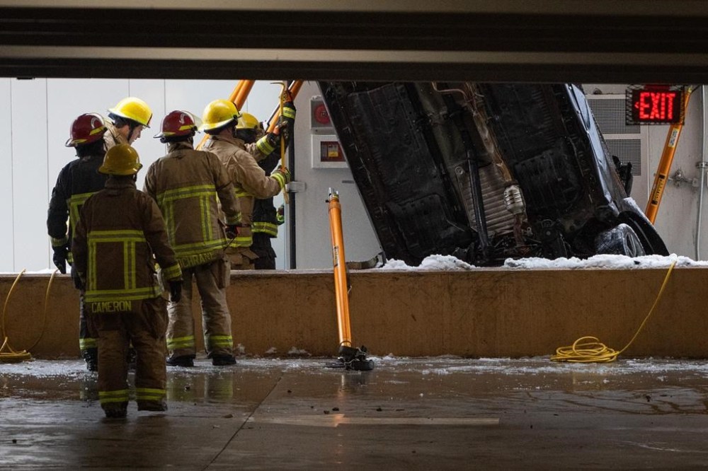 Vancouver Fire and Rescue Services attend to an accident at the University of British Columbia campus, where a car plunged off the second floor of a multi-storey parkade in Vancouver on Wednesday, Jan. 17, 2024. Police have confirmed the driver of the car was killed in the crash. THE CANADIAN PRESS/Ethan Cairns