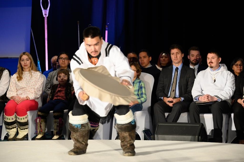 Prime Minister Justin Trudeau and Nunavut Premier P. J. Akeeagok watch a traditional drum dancer at the signing of the Nunavut devolution agreement in Iqaluit, Thursday, Jan. 18, 2024. THE CANADIAN PRESS/Dustin Patar