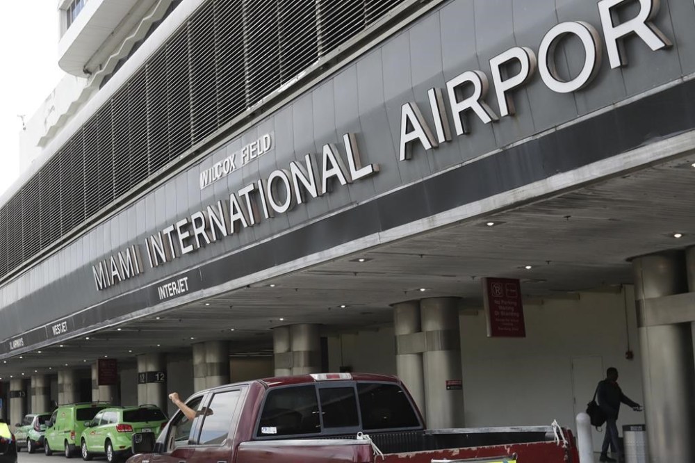 FILE - Vehicles pass the entrance to Miami International Airport in Miami Tuesday, May 12, 2020. A cargo plane made an emergency landing, Thursday Jan. 18, 2024, at Miami International Airport after experiencing engine failure shortly after takeoff, an airline spokesperson said. (AP Photo/Wilfredo Lee, File)