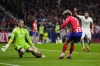Real Madrid's goalkeeper Andriy Lunin saves a shot from Atletico Madrid's Antoine Griezmann during their Copa del Rey round of 16 soccer match in Madrid, Spain, Thursday, Jan. 18, 2024. (AP Photo/Manu Fernandez)