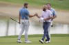 Sam Burns, left, shakes hands with Erik Barnes on the 18th green at the Nicklaus Tournament Course at PGA West during the second round of the American Express golf tournament Friday, Jan. 19, 2024, in La Quinta, Calif. (AP Photo/Ryan Sun)