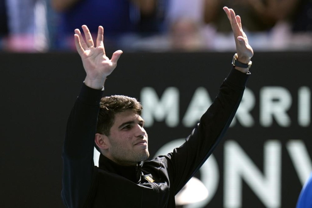 Carlos Alcaraz of Spain waves after defeating Shang Juncheng of China in their third round match at the Australian Open tennis championships at Melbourne Park, Melbourne, Australia, Saturday, Jan. 20, 2024. (AP Photo/Andy Wong)