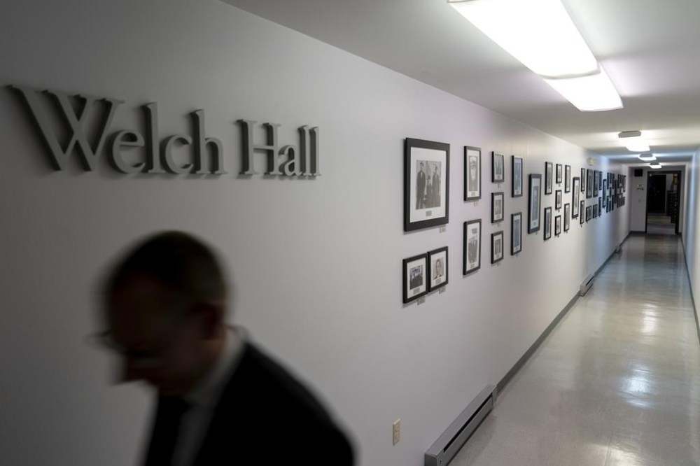 Historical photos hang along a basement corridor connecting two buildings of the John Birch Society at their headquarters in Appleton, Wis., Thursday, Nov. 17, 2022. (AP Photo/David Goldman)