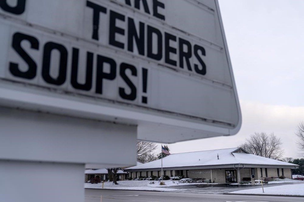 The John Birch Society headquarters stands across from a restaurant on a commercial street in Appleton, Wis., Thursday, Nov. 17, 2022. (AP Photo/David Goldman)