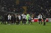 Referee Enzo Maresca, eight from left, match officials, right, and Udinese's players gather as the Italian Serie A soccer match between Udinese and AC Milan is suspended, at the Friuli stadium in Udine, Italy, Saturday, Jan. 20, 2024. Racist abuse aimed at AC Milan goalkeeper Mike Maignan prompted a top-tier Italian league game at Udinese to be suspended briefly during the first half. Maignan left the field after the insults which followed a goal for Milan. (Andrea Bressanutti/LaPresse via AP)