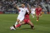 Thailand's Pathompon Charoenrattanapirom, front, is challenged by Oman's Ahmed Al-Khamisi during the Asian Cup Group F soccer match between Thailand and Oman at Abdullah Bin Khalifa Stadium in Doha, Qatar, Sunday, Jan. 21, 2024. (AP Photo/Thanassis Stavrakis)