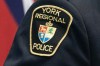 Police say they have charged 11 people with close to 100 offences after a months-long investigation into an alleged car theft ring operating in the Toronto area and other parts of southwestern Ontario. A York Regional Police patch is shown in a Dec. 19, 2022 photo in Aurora, Ont. THE CANADIAN PRESS/Arlyn McAdorey