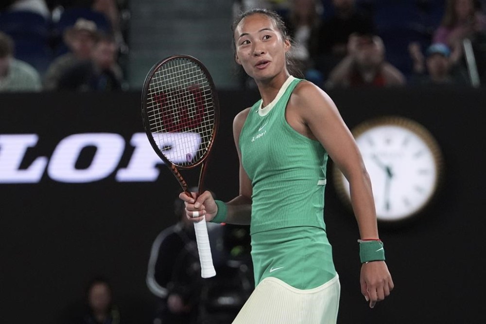 Zheng Qinwen of China reacts after defeating Oceane Dodin of France in their fourth round match at the Australian Open tennis championships at Melbourne Park, Melbourne, Australia, Monday, Jan. 22, 2024. (AP Photo/Andy Wong)