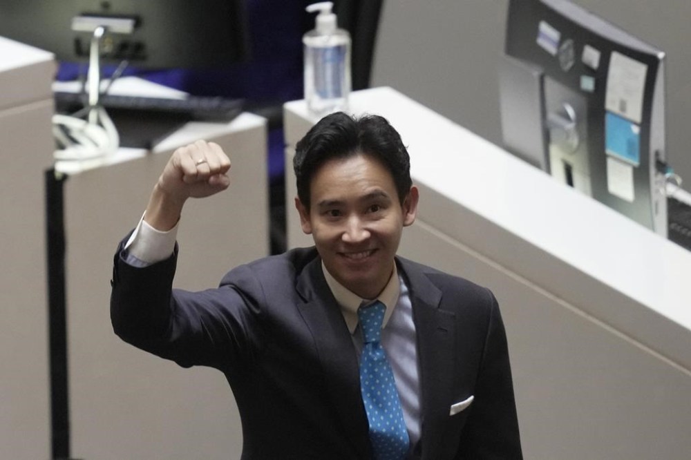 FILE - Pita Limjaroenrat, the leader of Move Forward Party and top winner in May's general election, raises his hand as he leaves Parliament in Bangkok, Thailand, on July 19, 2023. Thailand's Constitutional Court is set to decide Wednesday, Jan. 24, 2024 whether popular politician Pita Limjaroenrat, who was blocked from becoming prime minister, should now lose his seat in Parliament. (AP Photo/Sakchai Lalit, File)