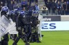 Riot police stand guard after fans threw flares before the Cyprus' cup soccer match between AEL and Apollon at Alpha Mega stadium in Kolossi near Limassol, Cyprus, Wednesday, Jan. 24, 2024. A key Cyprus Cup battle between perennial Limassol rivals Apollon and AEL has been called off after a number of fans invaded the pitch and hurled flares at each other prior to the start of the match. (AP Photo)