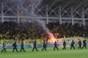 Riot police stand guard after fans threw flares before the Cyprus' cup soccer match between AEL and Apollon at Alpha Mega stadium in Kolossi near Limassol, Cyprus, Wednesday, Jan. 24, 2024. A key Cyprus Cup battle between perennial Limassol rivals Apollon and AEL has been called off after a number of fans invaded the pitch and hurled flares at each other prior to the start of the match. (AP Photo)
