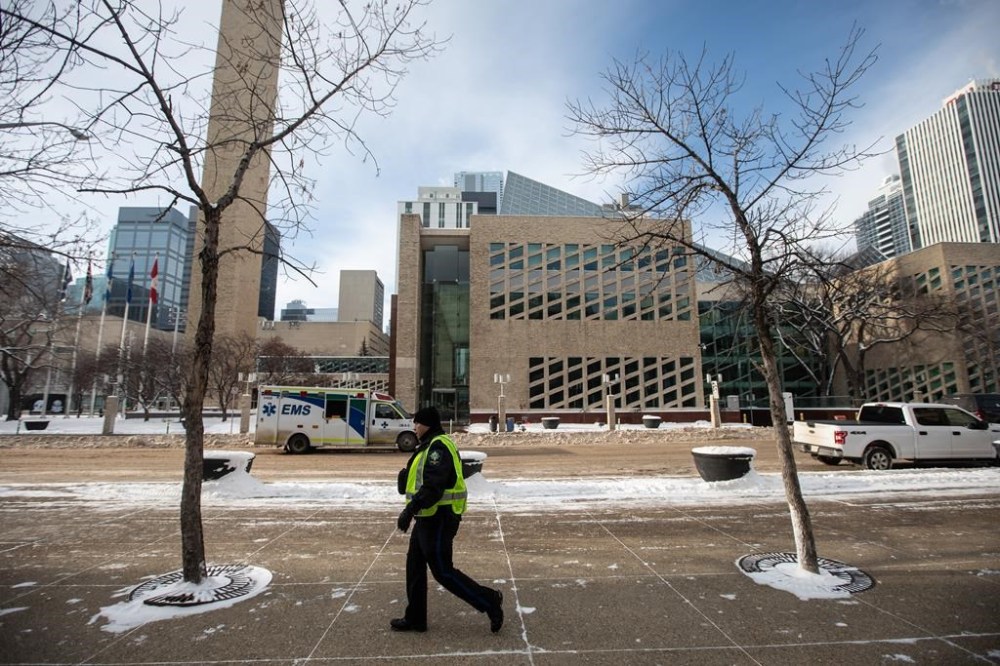 A man is facing weapons charges after shots were fired Tuesday morning at Edmonton City Hall. A sheriff patrols the building during an investigation, in Edmonton, Tuesday, Jan. 23, 2024. THE CANADIAN PRESS/Jason Franson