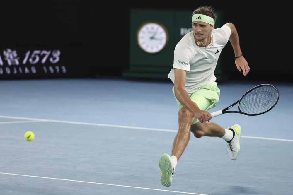 Alexander Zverev of Germany plays a backhand return to Carlos Alcaraz of Spain during their quarterfinal match at the Australian Open tennis championships at Melbourne Park, Melbourne, Australia, Thursday, Jan. 25, 2024. (AP Photo/Asanka Brendon Ratnayake)